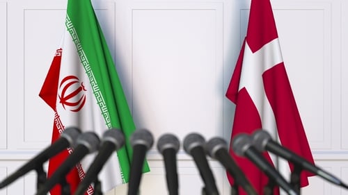 Iran And Denmark Flags Waving For Diplomatic Press Conference