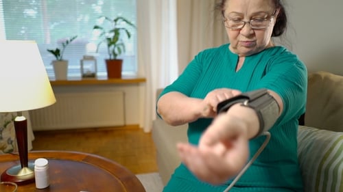 Senior Woman Checks Blood Pressure at Home