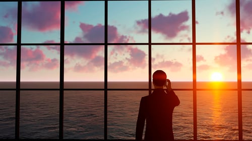 Businessman Silhouette Overlooking Sunset Ocean View
