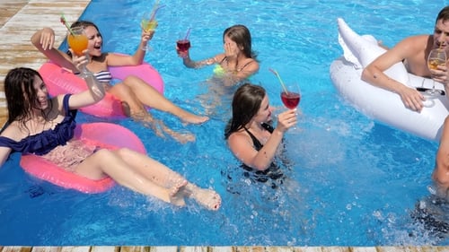 Party in Pool Luxurious Life of Friends with Colored Cocktails Swim on Inflatable Rings Into