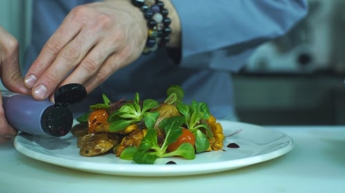 the Chef Pours Sauce on a Plate for Serving