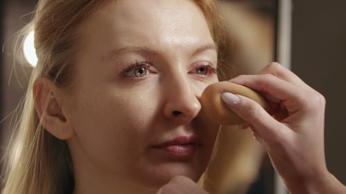 Woman Having Makeup Applied With Sponge, Close Up