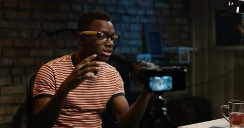 Young Man Talking on Camera in a Garage