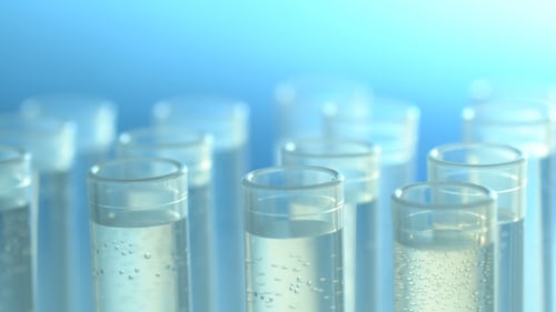 Laboratory Test Tubes with Pipette Dripping Liquid