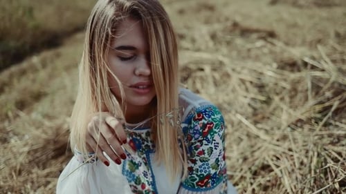 Smiling Woman in a Rural Field with Embroidered Blouse