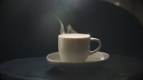 Steaming Coffee Cup on Saucer Close Up