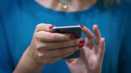 Woman's Hands Using Mobile Phone