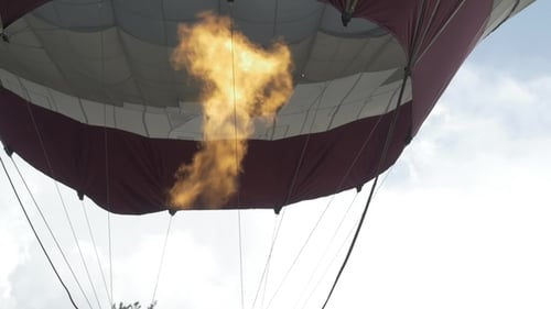 Hot Air Balloon Inflating with Flame in Sky