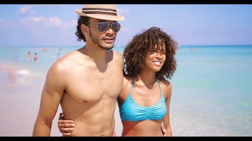 Couple Walking Together on Beach in Summertime
