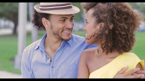 Smiling Couple Embracing in Lush Green Park