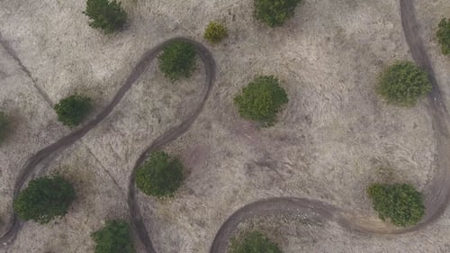 Aerial Top View of Motocross Racing Track Between Trees
