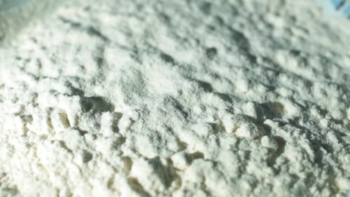 White Flour Poured in a Bright Close-Up Shot