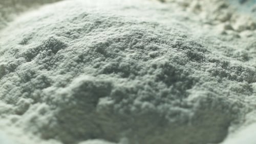 White Cake Flour Falling Through a Sieve