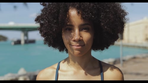 Smiling Woman with Curly Hair Close-Up Portrait
