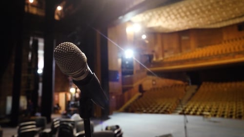 Microphone on the Stage and Empty Hall During the Rehearsal. Microphone on Stage with Stage-lights