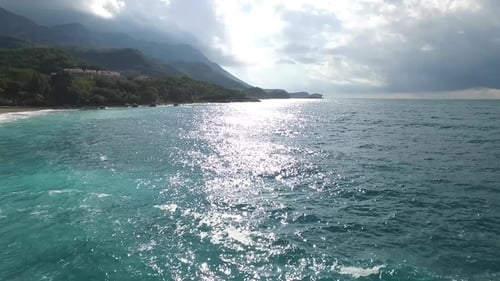 Azure Beach with Rocky Mountains and Clear Water. Footage. Aerial