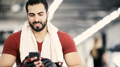 Man with Phone in Gym
