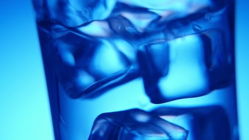 Ice Cubes Floating in Glass of Water, Macro