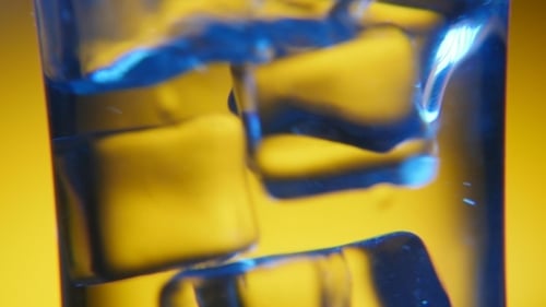 Ice Cubes in Glass with Blue and Yellow Light