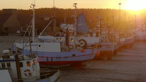 Fishing Boats on Sandy Shore at Sunset