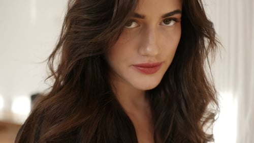 Woman Posing with Brown Hair and Makeup