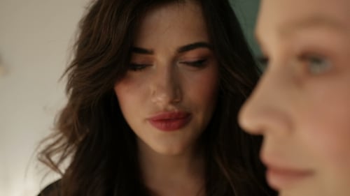 Two Young Women Posing in an Indoor Setting