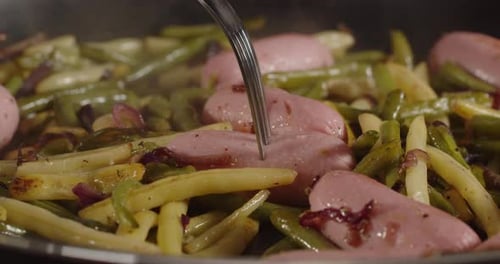 A Sausage With Asparagus Is Pricked With A Fork. Cooking