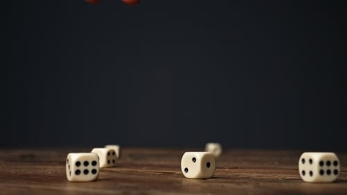 Dice Falling on Wooden Table in Slow Motion