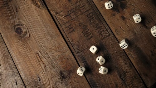 Rolling Dice on Rustic Wooden Table