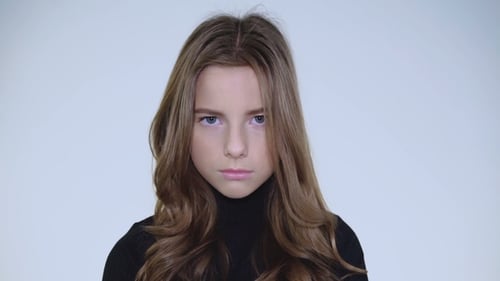 Young Woman with Wavy Hair Lifting Her Gaze