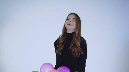 Cheerful Woman with Colorful Balloons Celebrates