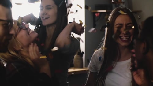 Friends Celebrate Together with Gold Confetti at Party