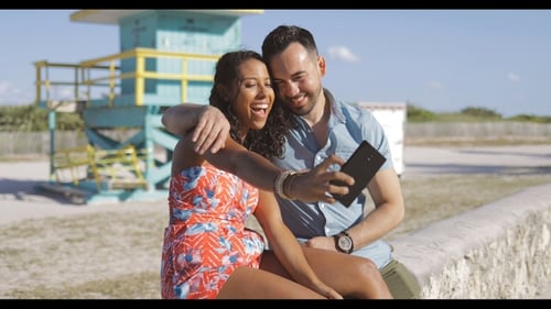 Smiling Couple Taking Selfie on Beach Vacation