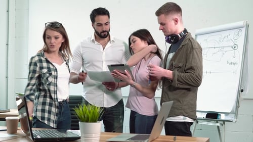 Office Workers Discuss Diagrams