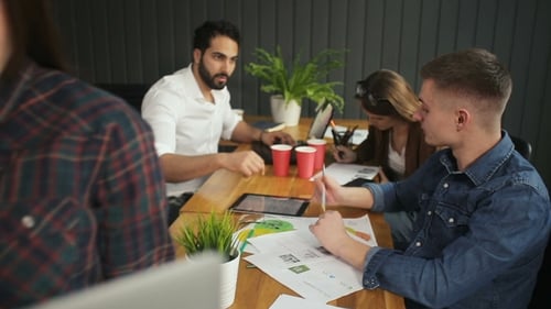 Team Working Together at Desk in Office