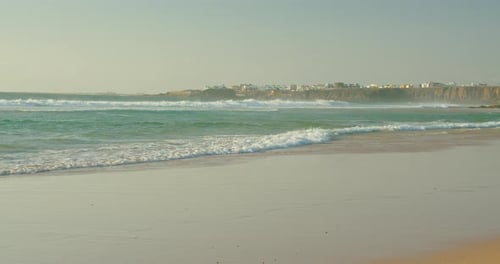 Wide Shot Seascape Big Waves Pattern Roll Splash on Shore Side Blue Sky Background at Sunny Day