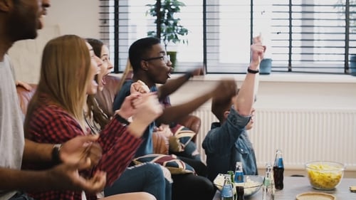 Friends Cheering Sports Victory at Home