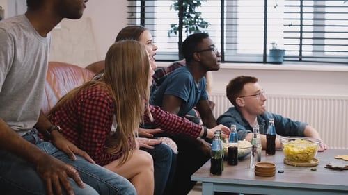 Excited Friends Watching a Sporting Event at Home