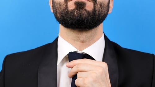 Businessman Carefully Arranges His Tie
