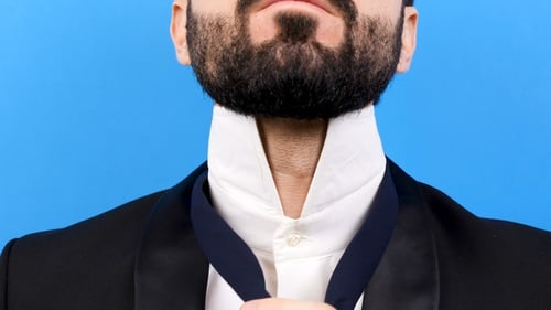 Man in Suit Tying Tie Close Up