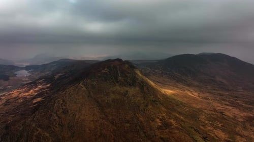 Killarney, Kerry, Ireland, March 2022. Drone pulls west above Molls Gap under a moody sky with views