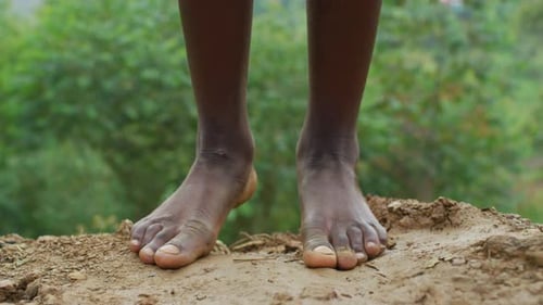 Bare Feet Standing on Dirt Ground Outdoors
