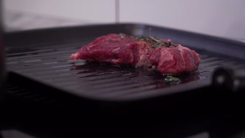 Raw Meat Placed on Hot Grill Pan