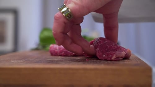 Man Cuts Red Meat
