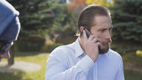 Rich Businessman Talks on a Phone and Runs Away a Poor Homeless Man
