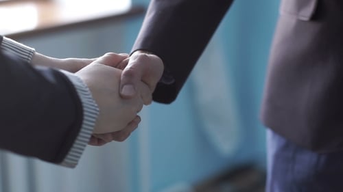 Business Handshake Conveying Agreement in a Workplace