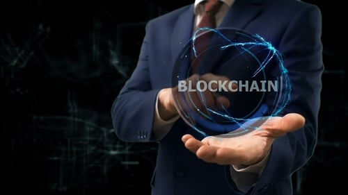 Businessman Interacting with Holographic Blockchain Sphere