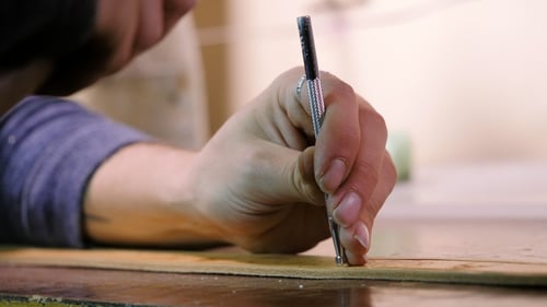 Leather Master Manufacturer Working. Craftsman Knocks with Hammer To Stick Two Parts. Manufacture
