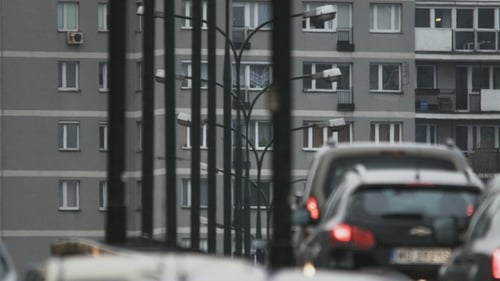 Traffic on City Bridge with Apartment Building