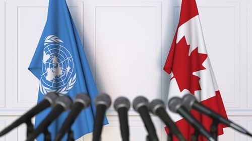 Flags of the United Nations and Canada at International Press Conference
